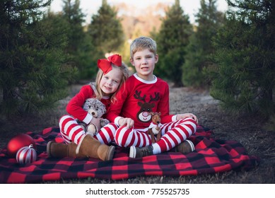 Adorable Siblings at a Christmas Tree Farm in Christmas Pajamas