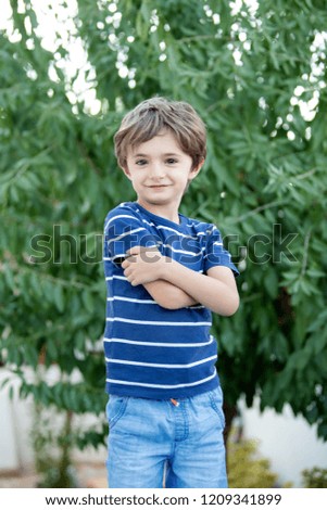 Similar – Cute little boy seated on the wall of a castle