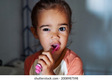 An Adorable Spanish Baby Girl Washing Her Teeth In The Bathroom