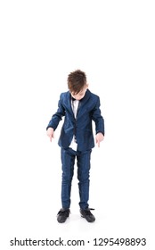 Adorable Stylish Handsome Boy Posing In Modern Kids Suit And Showing To His Shoes, Ugly Shoes Do Not Match With The Suit, Isolated On White Background