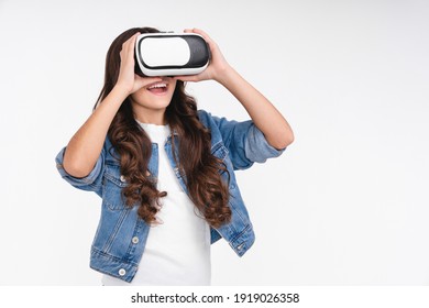 Adorable teenage girl using VR glasses isolated over white background - Powered by Shutterstock