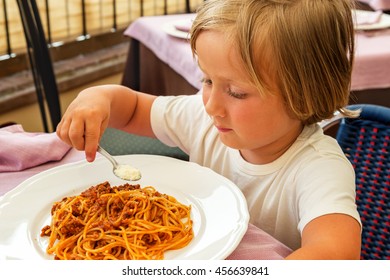 Adorable Toddler Boy Eating Spaghetti Bolognese With Cheese