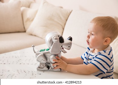 Adorable Toddler Boy Playing With Interactive Toy. Child With Robot Dog. Indoors. Activities For Small Children. Communication And Digital Concept.