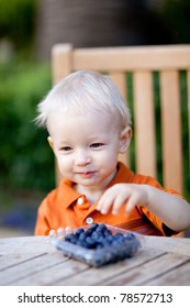 Adorable Toddler Eating Blueberries