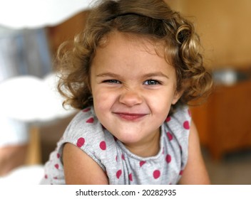 Adorable Toddler Girl With Curly Hair, Scrunching Nose