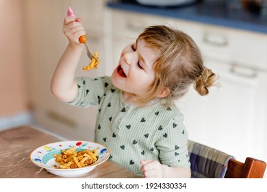 Adorable Toddler Girl Eat Pasta Macaroni Bolognese With Minced Meat. Happy Child Eating Fresh Cooked Healthy Meal With Noodles And Vegetables At Home, Indoors.