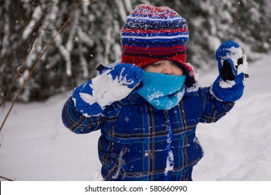 adorable toddler playing in the cold winter snow