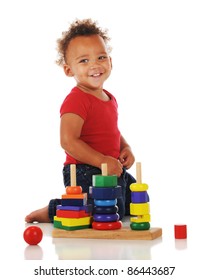 An Adorable Toddler Playing With A Stacking Toy.  On A White Background.