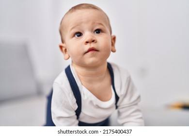 Adorable Toddler Sitting On Sofa At Home