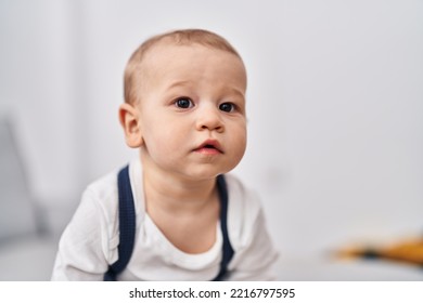 Adorable Toddler Sitting On Sofa At Home