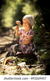 Adorable Toddler Throwing Leaves Girl In The Park. Autumn 