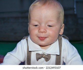 Adorable Toddler In Tie Shows Tongue