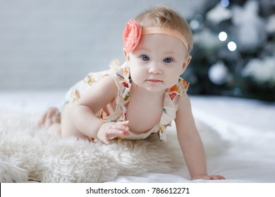 Adorable two month old baby girl lying on the pillow and looking into the camera. Portrait of adorable baby girl