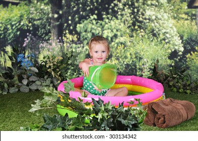 An Adorable Two Year Old Outside Happily Playing In A Small Kiddie Pool.