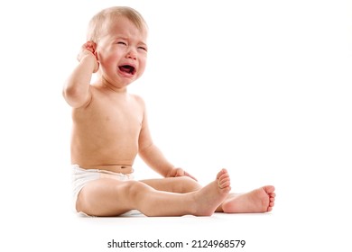 Adorable upset little boy in diaper is sitting and crying on white background. - Shutterstock ID 2124968579