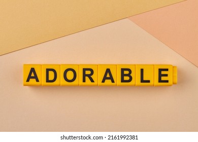 Adorable Word Written On Alphabet Blocks On Light Background Close Up. Inspiring Great Affection Or Delight.