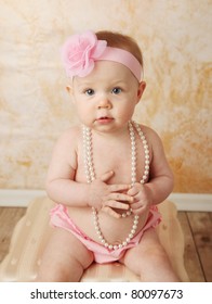 Adorable Young Baby Girl Wearing A Vintage Pearl Necklace And Pink Rose Headband