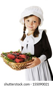 An adorable young Pilgrim girl carrying a basket of lobster (a likely offering at the first Thanksgiving).  On a white background.