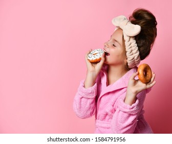 Adorable Young Teenage Girl In A Hair Bandand And A Plush Robe Is About To Eat Mouthwatering Glazed Donuts