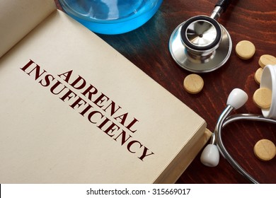 Adrenal insufficiency  written on book with tablets. Medicine concept.