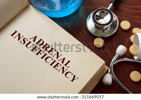 Adrenal insufficiency  written on book with tablets. Medicine concept.