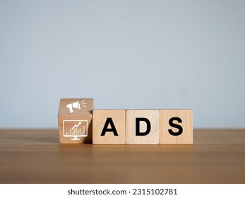 ADS advertisements Advertising on online platforms marketing strategy Promotion of products targeting online customers on a wooden cube - Shutterstock ID 2315102781