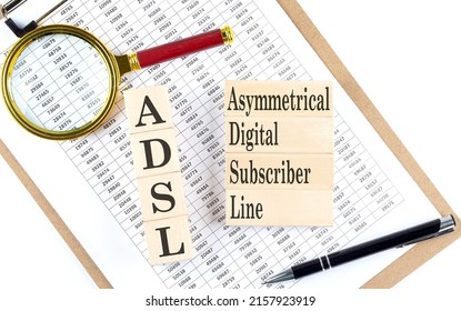 ADSL - Asymmetrical Digital Subscriber Line text on wooden block on a chart background
