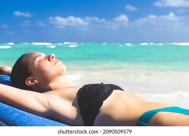 Adult 34-years Old, White Caucasian Ethnicity, Woman Lying Down On The Beach And Enjoying Her Vacation In The Tropical Climate.