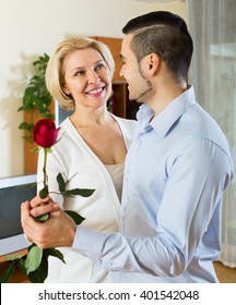 Adult American Son Asking Senior Mother To Dance At Home