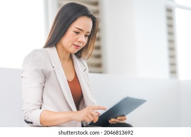 Adult Asian Businesswoman Using Digital Tablet Computer and Working Outdoors Office