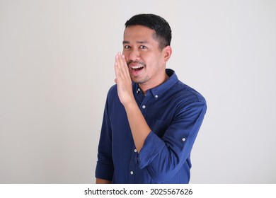 Adult Asian Man Doing Whisper Gesture Isolated White Background