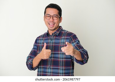 Adult Asian Man Pointing Forward While Giving Thumb Up