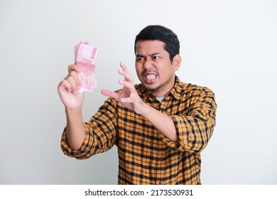 Adult Asian Man Showing Angry Expression When Trying To Grab Money That He Hold