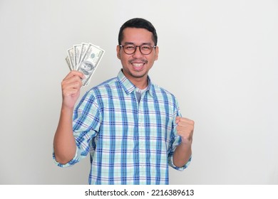 Adult Asian Man Showing Excited Expression While Holding US Dollar Money