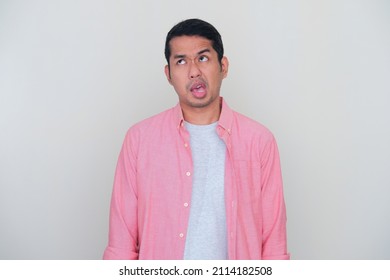 Adult Asian Man Showing Funny Ugly Face Expression To Express His Bad Mood