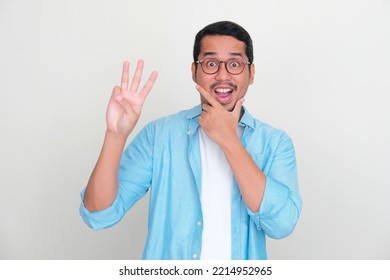 Adult Asian Man Showing Three Fingers Sign With Wow Expression