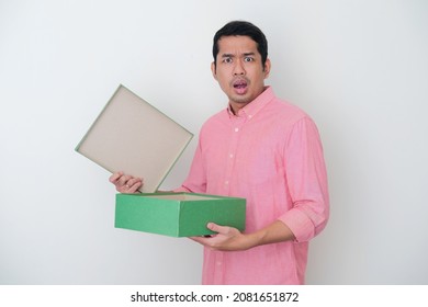 Adult Asian Man Showing Unhappy Expression When Open A Gift Box