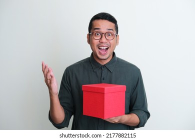 Adult Asian Man Showing Wow Face Expression When Holding A Gift Box