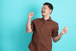 The Adult Asian Man In Smart Casual Clothes Standing On The Green Background Background.