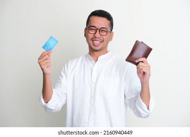 Adult Asian Man Smiling Confident While Showing His Wallet And Credit Card