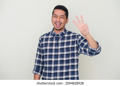 Adult Asian man smiling happy while showing three fingers sign - Shutterstock ID 2094828928