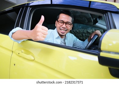 Adult Asian Man Smiling Happy And Give Thumb Up From Inside Car Driver Seat Window