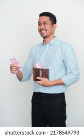 Adult Asian Man Smiling While Giving Money To Someone