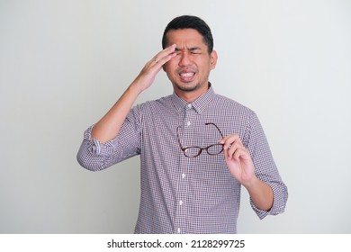 Adult Asian Man Suffer Sore Eyes While Holding His Glasses