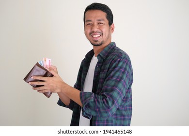 Adult Asian Man Take Paper Money From His Wallet With Happy Face