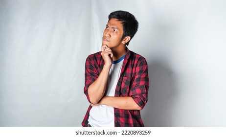 Adult Asian Man Wearing Red Flannel Shirt Showing Thinking Gesture