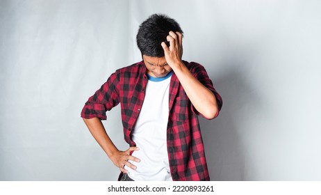 Adult Asian Man Wearing Red Flannel Shirt Showing Thinking Gesture