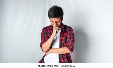 Adult Asian Man Wearing Red Flannel Shirt Showing Thinking Gesture