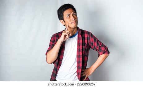 Adult Asian Man Wearing Red Flannel Shirt Showing Thinking Gesture