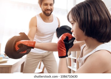 Adult Bearded Father Teaches Son To Box. Man Coaches Child To Strike. Concept Of Self Defense Training.